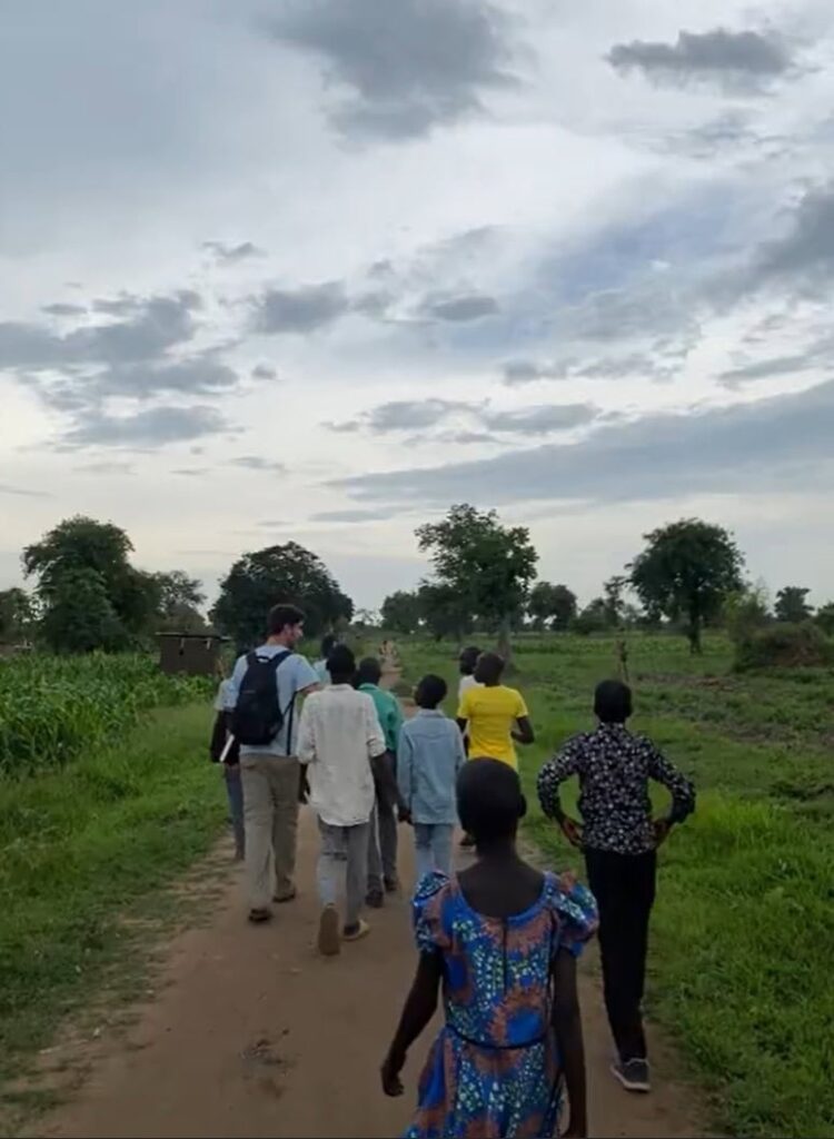 People walking down a dirt path