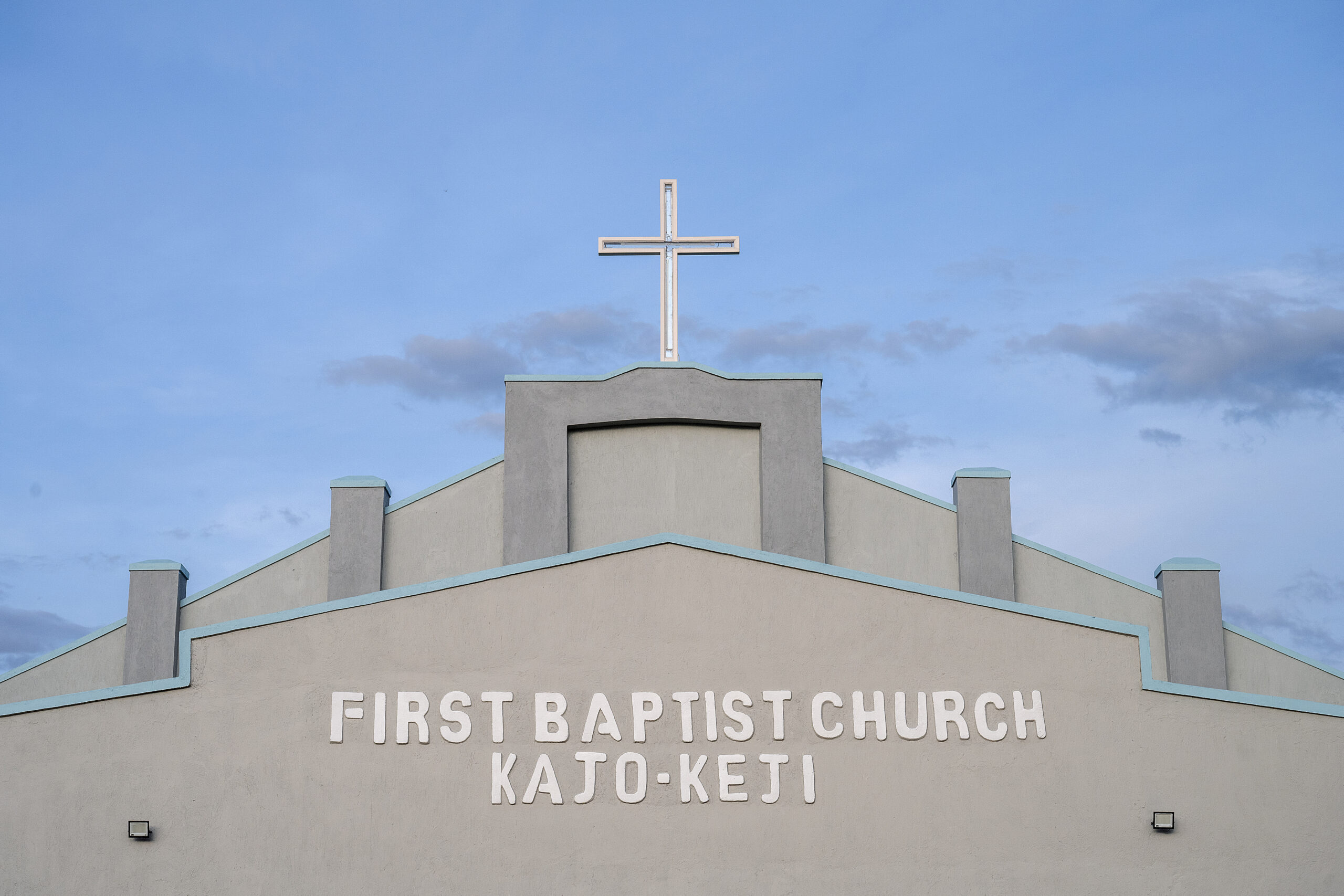 Cross atop First Baptist Church Kajo Keji against a blue sky