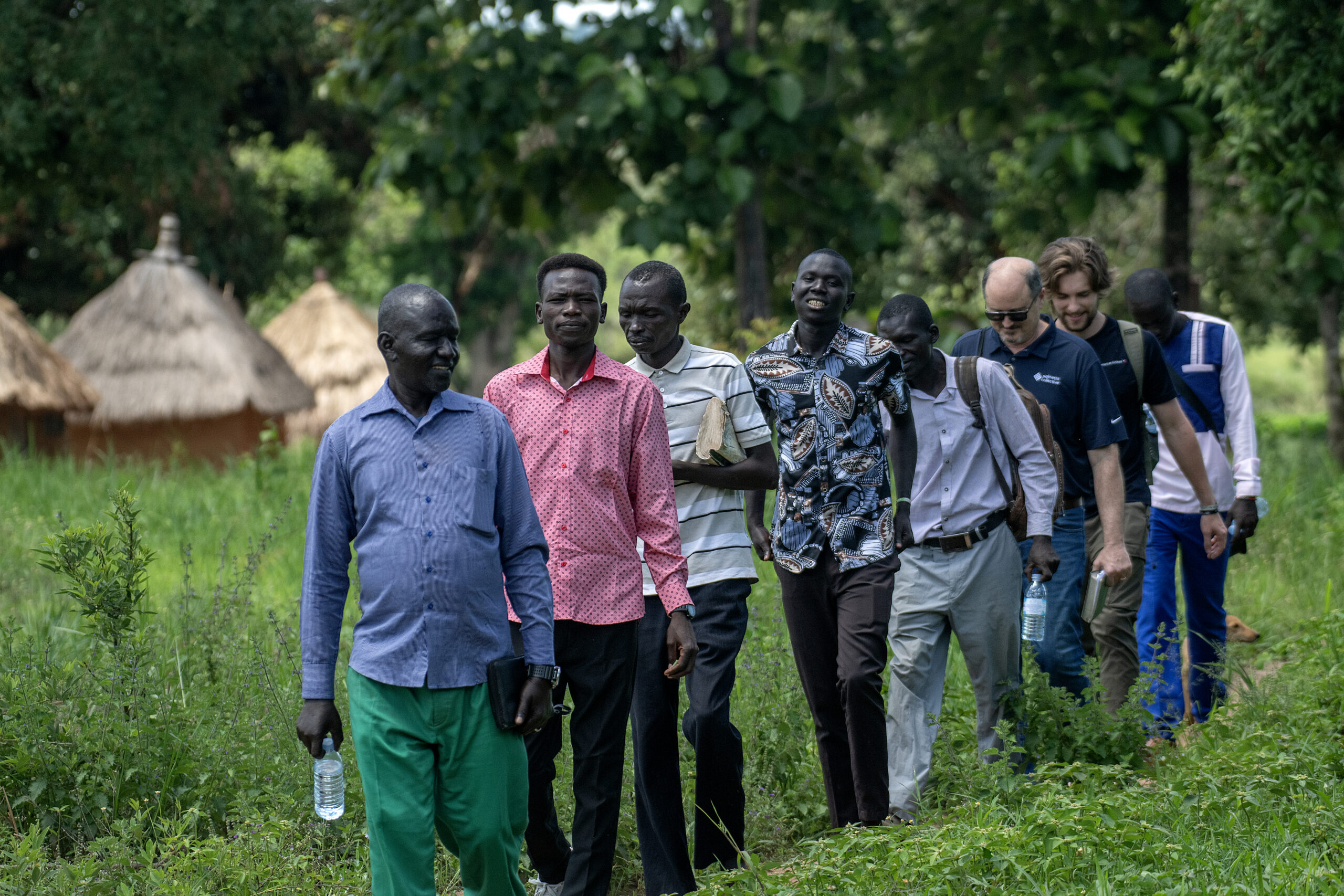 African pastors leading a walk through the countryside near Kajo Keji, with American teammates following