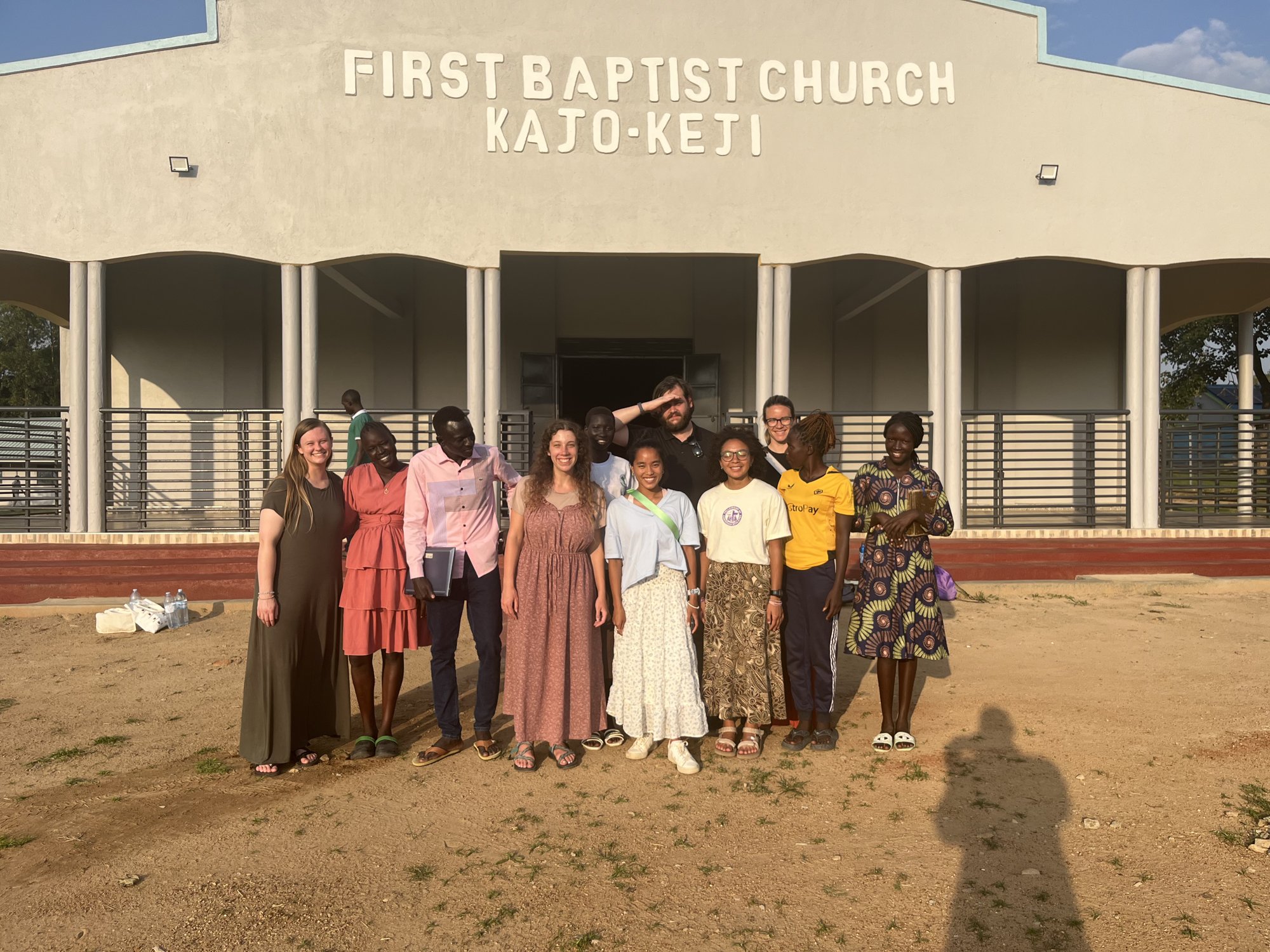 College team and South Sudanese partners in front of First Baptist Church Kajo-Keji