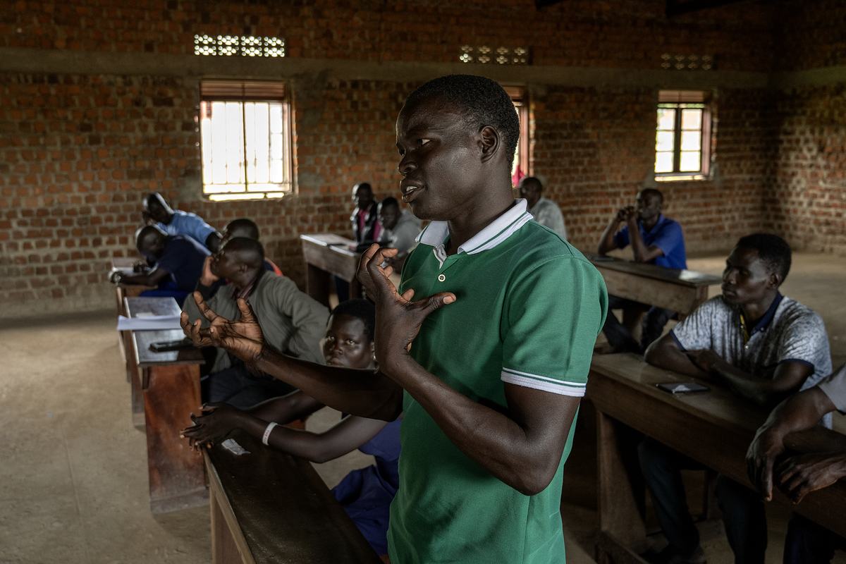 A NEATS student standing to answer a question during a lecture