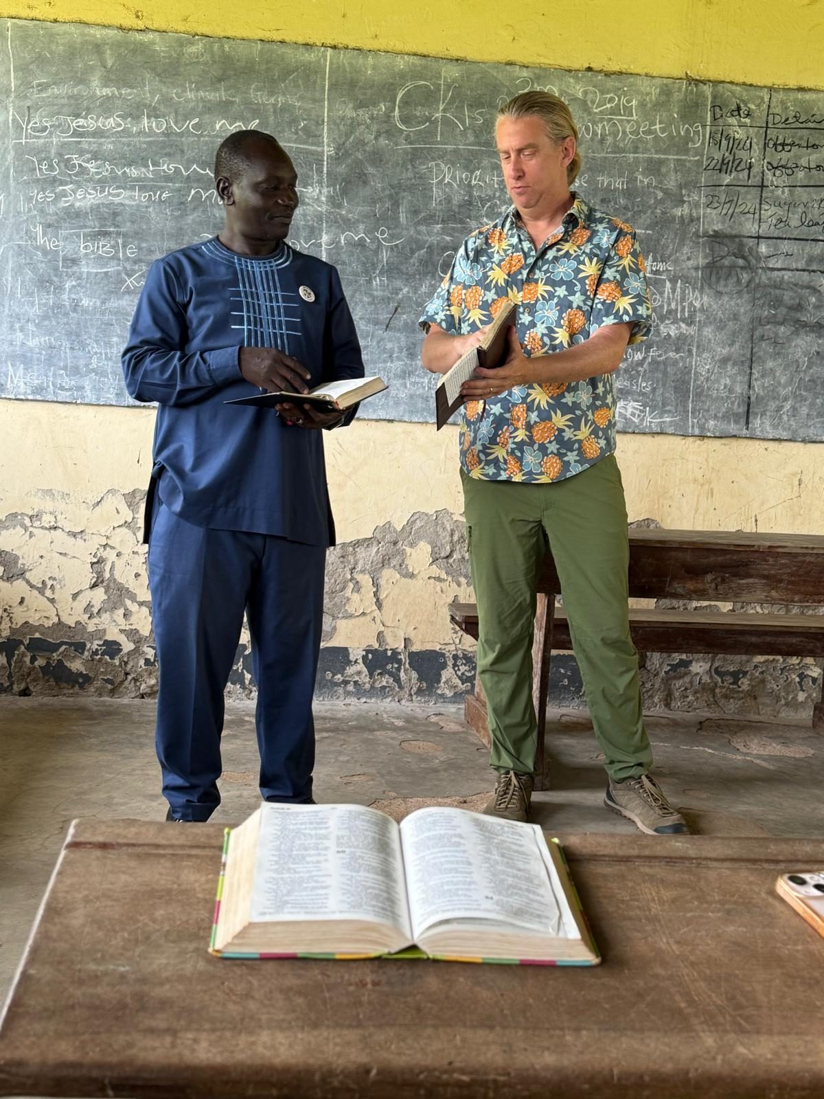 John Barnes teaching alongside a South Sudanese leader in a classroom in Kajo Keji