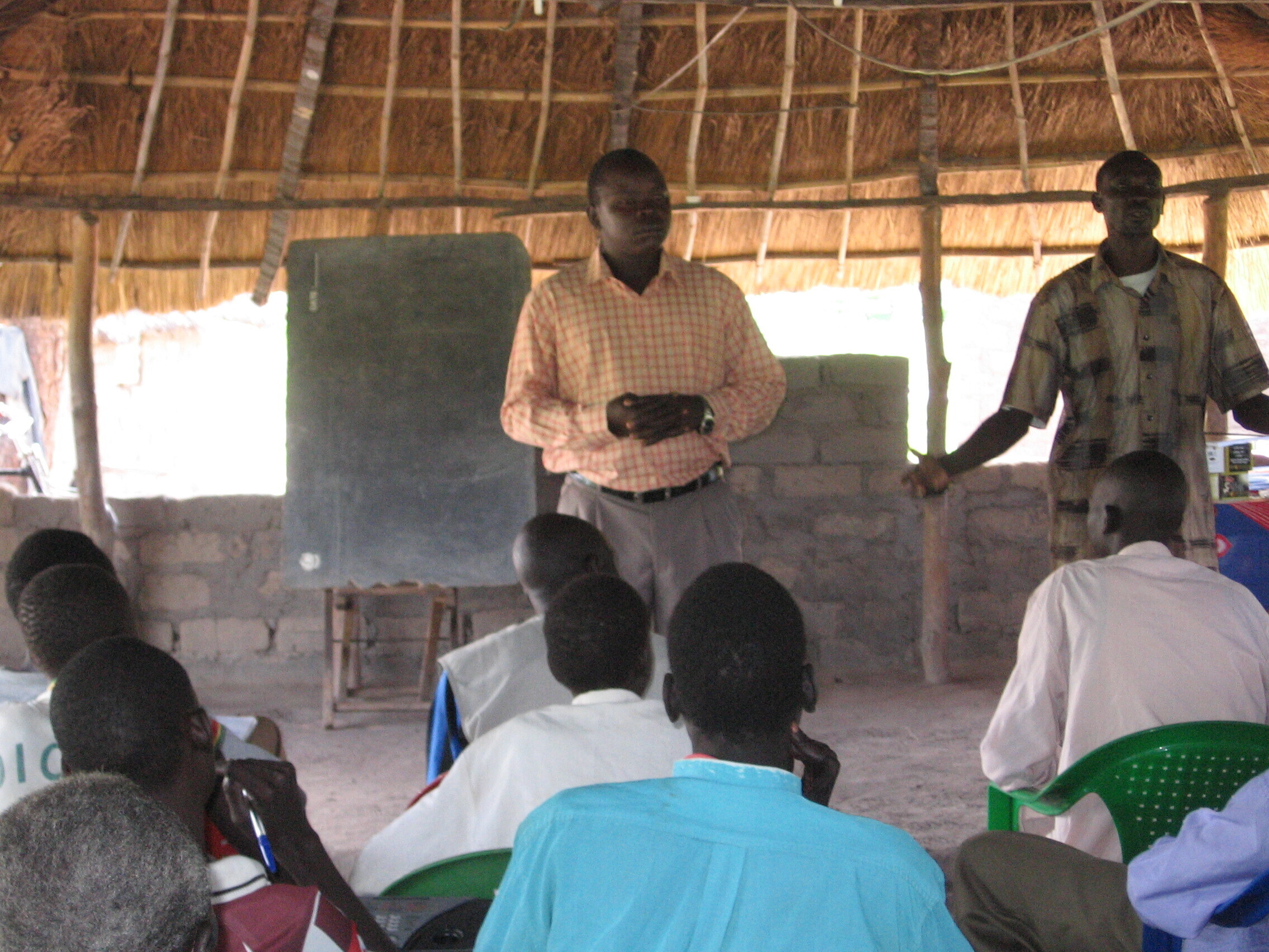 Translator speaking to a gathered group in South Sudan, 2006