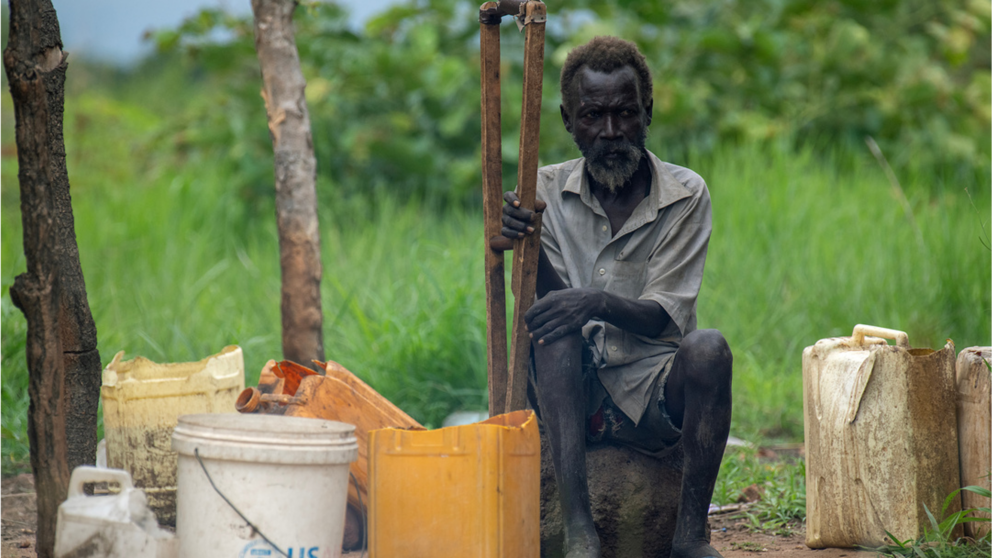 Man sitting with a walking stick in South Sudan