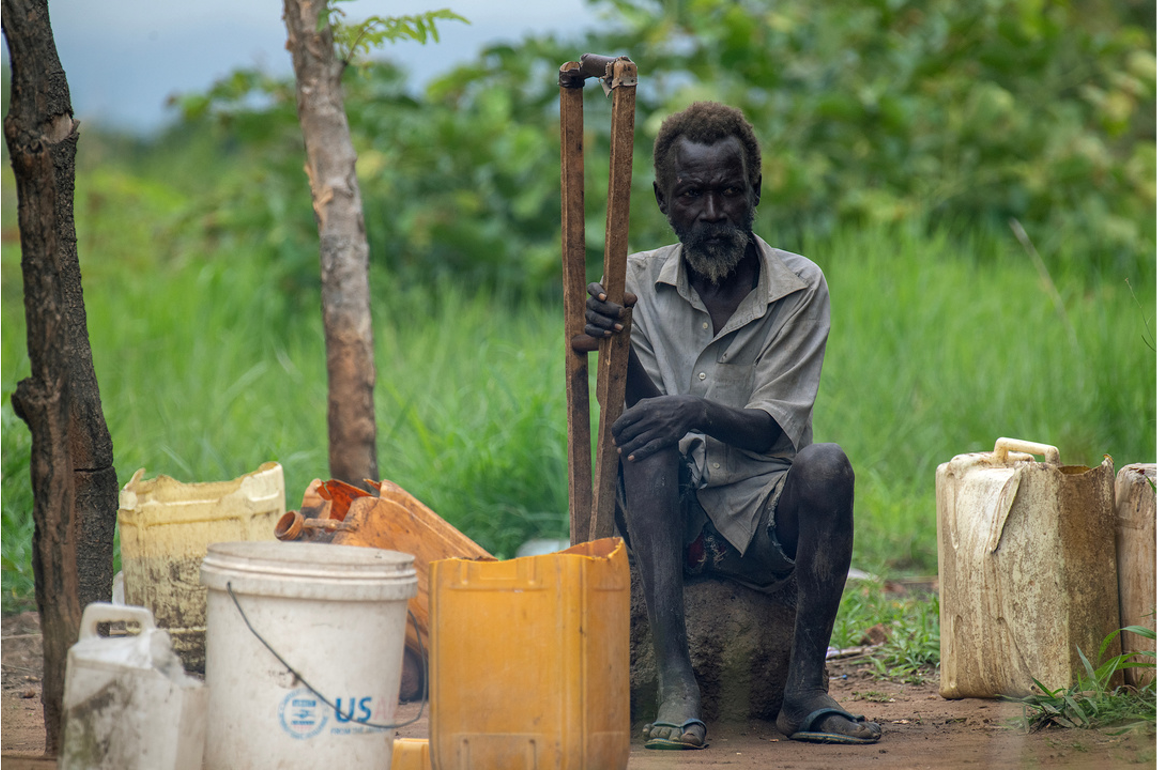 Man sitting with a walking stick in South Sudan