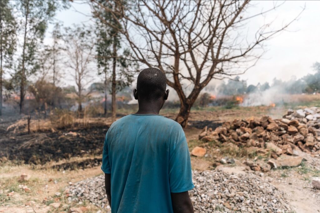 Man looking at home burning